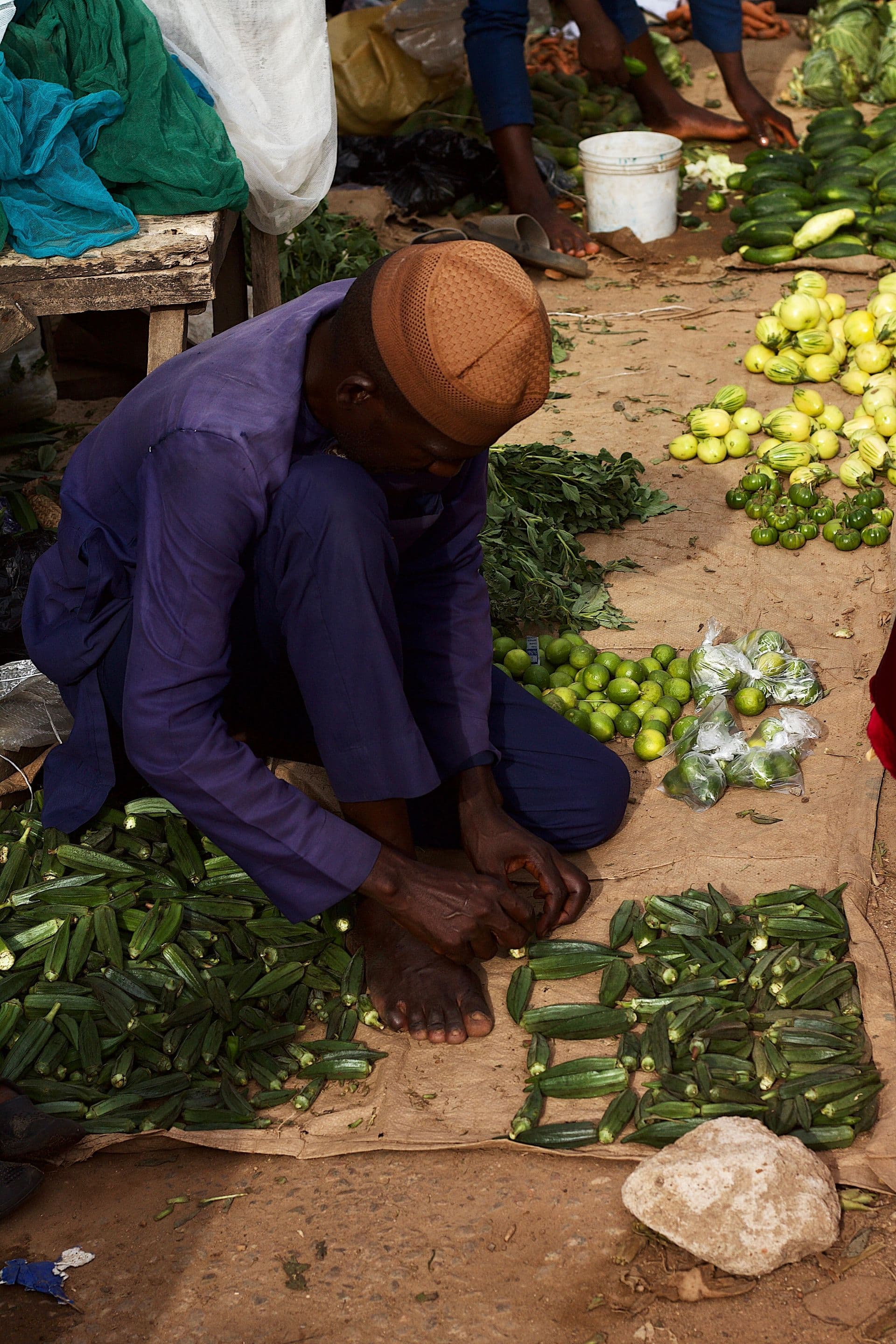 Market vendor arranging fresh produce